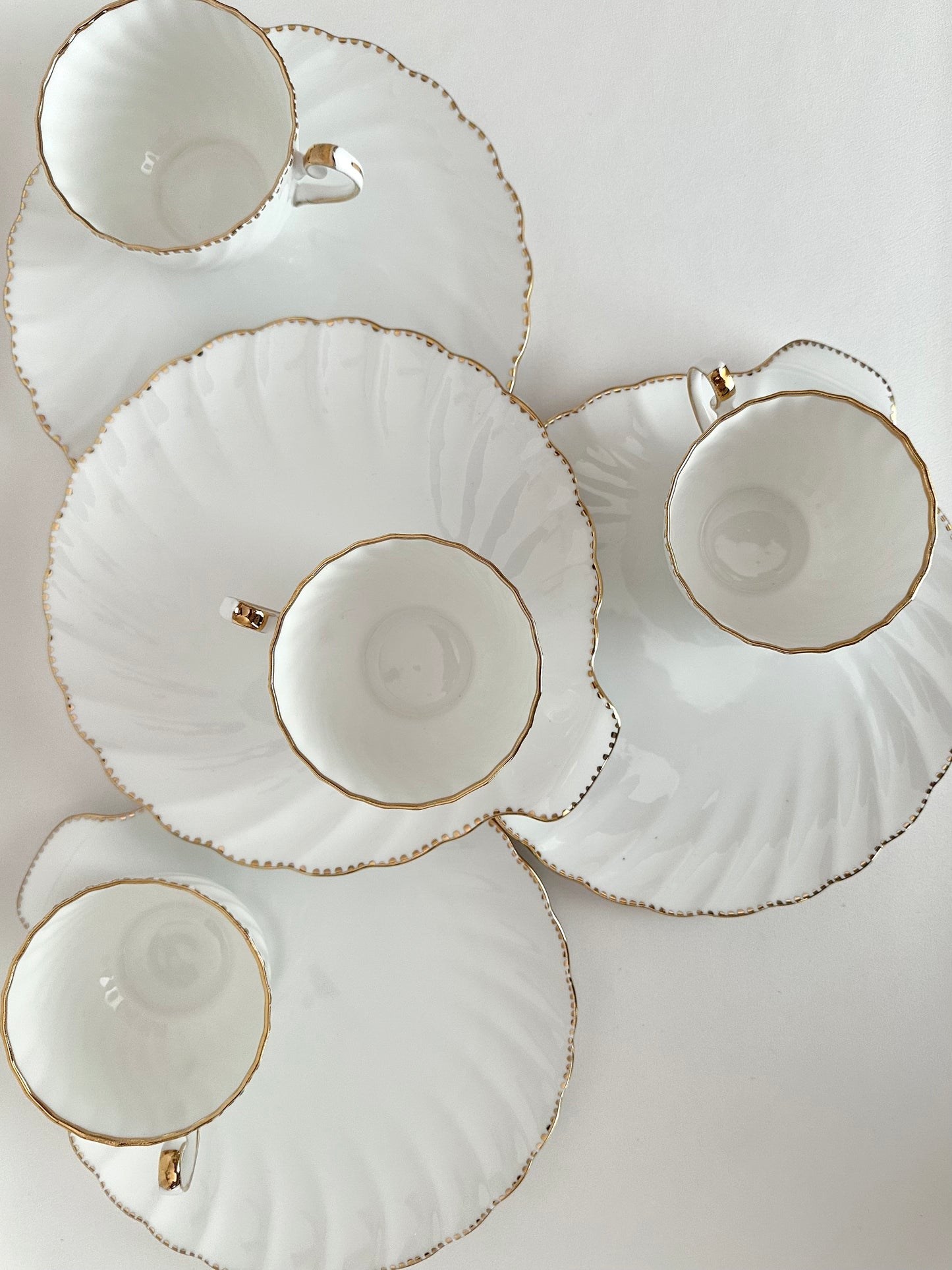 Vintage porcelain clamshell snack sets with plates and cups Set of four