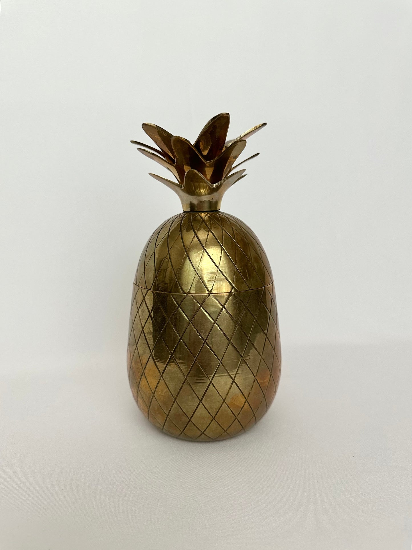 Vintage brass pineapple lidded canister and candleholder.
