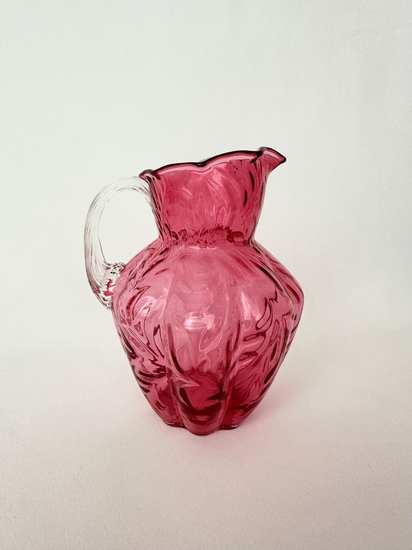 Vintage cranberry glass textured small pitcher or creamer by Fenton Glass.