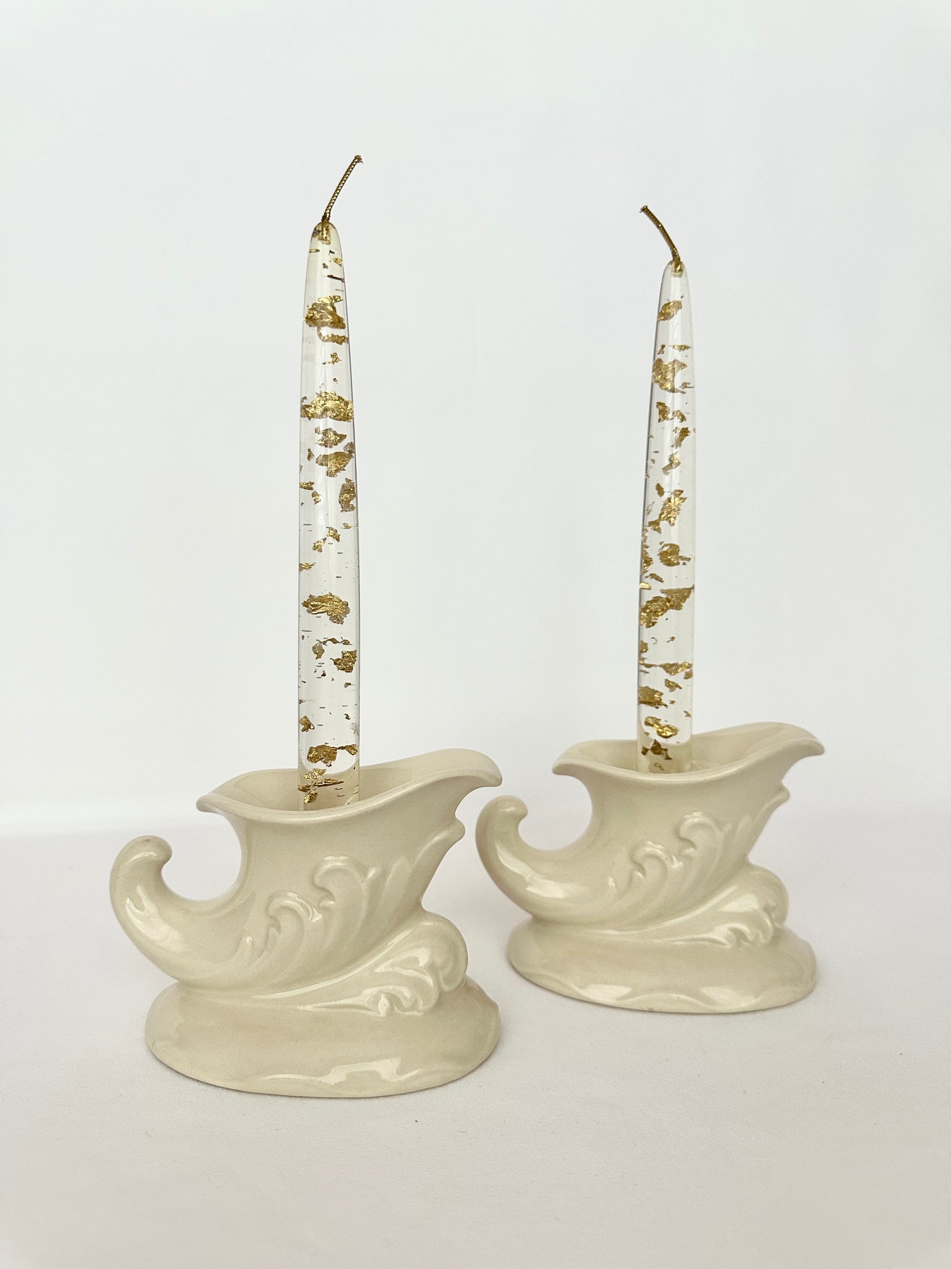 Cream ceramic cornucopia shaped candlestick holders set of two.