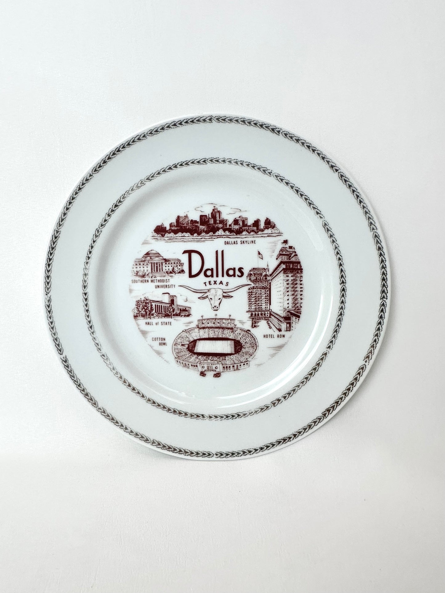 Vintage Dallas souvenir plate with maroon painted lettering and iconic city images with gold metallic trim