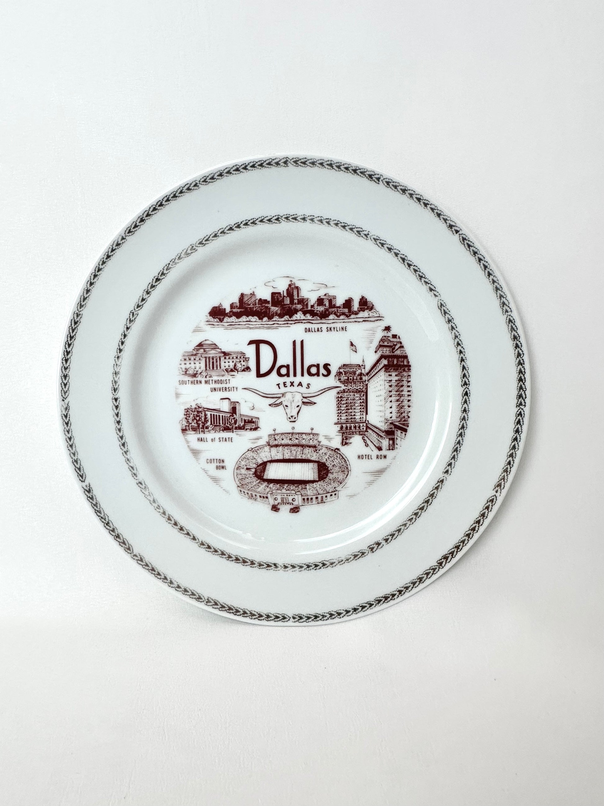 Vintage Dallas souvenir plate with maroon painted lettering and iconic city images with gold metallic trim