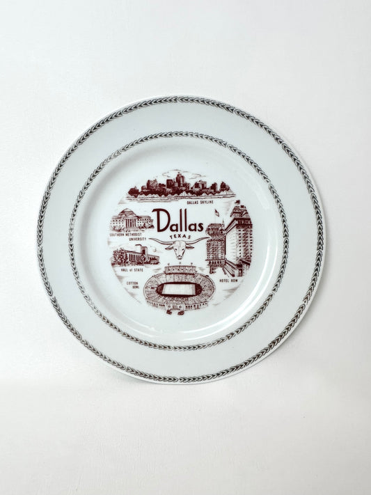 Vintage Dallas souvenir plate with maroon painted lettering and iconic city images with gold metallic trim