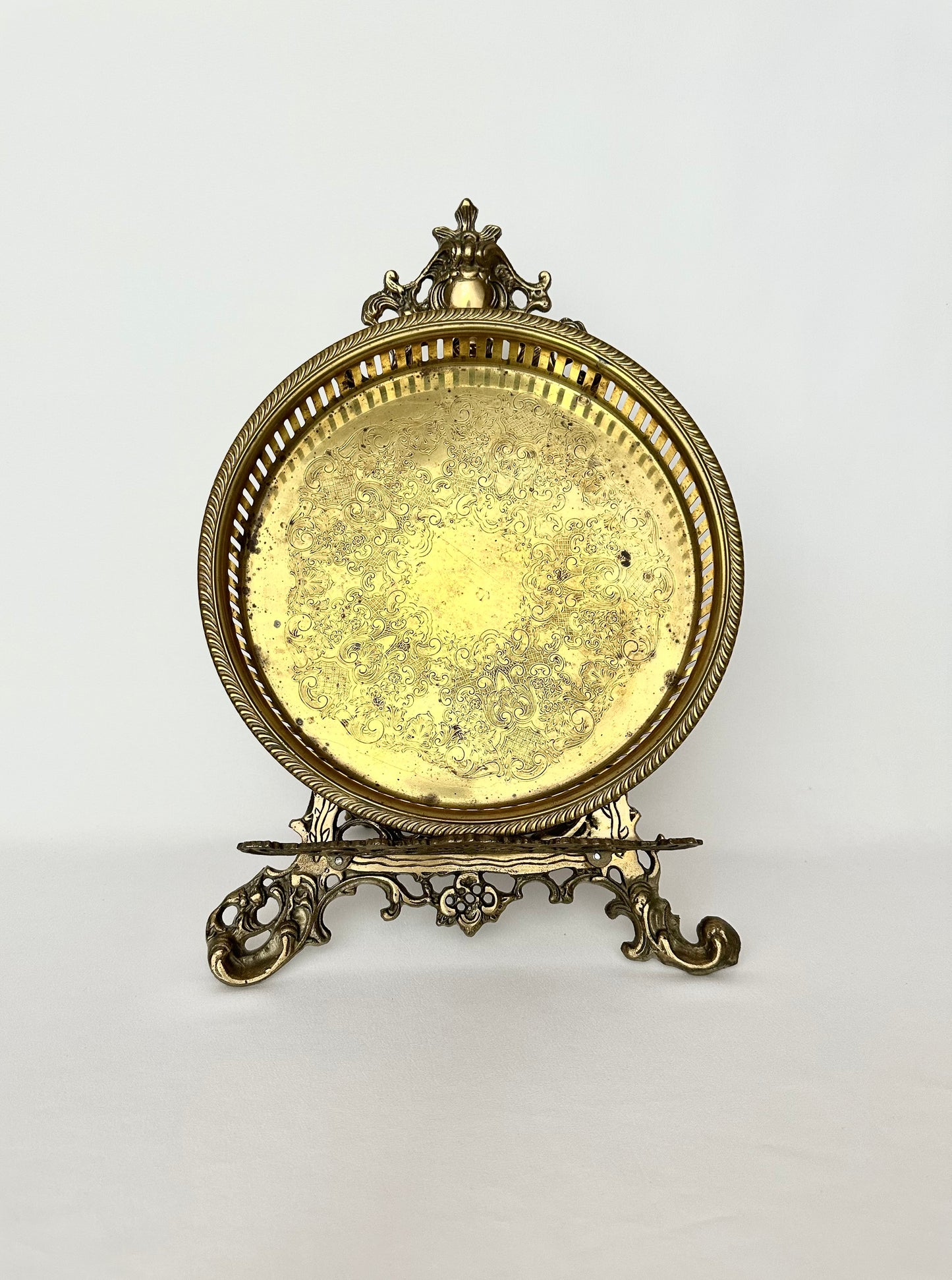 Vintage round etched brass gallery tray with botanical pattern. Has patina.