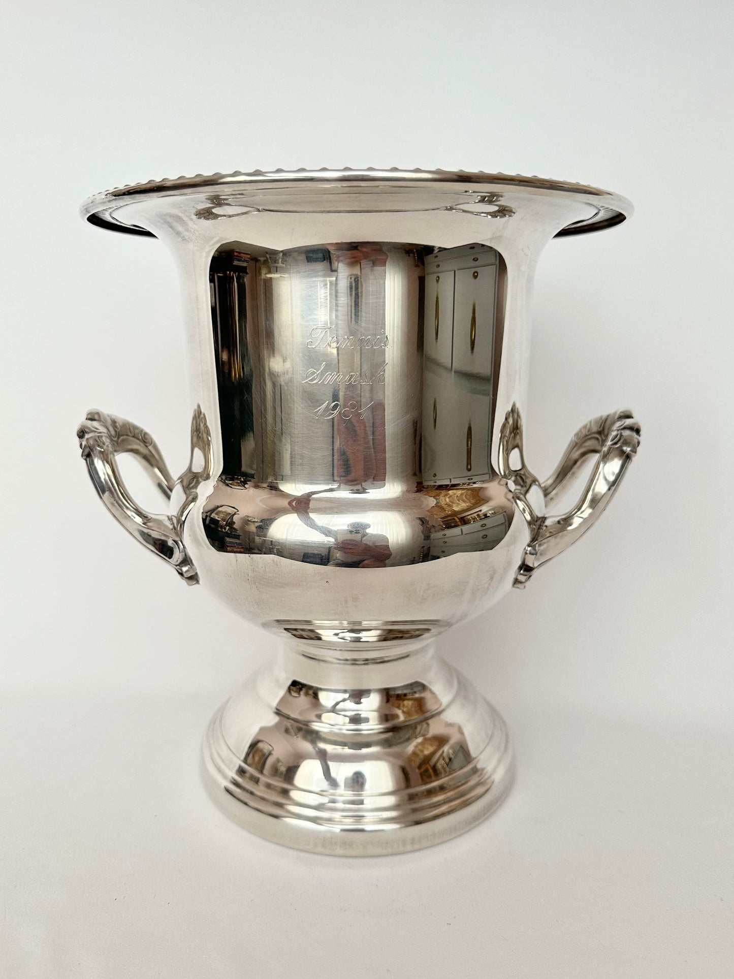 Vintage silverplate large trophy cup or champagne bucket with handles and footed base.