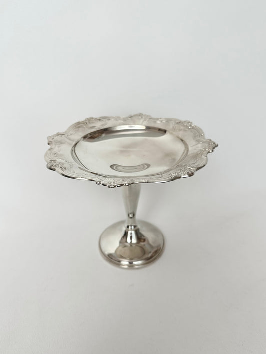 Vintage silverplate pedestal dish with scalloped embossed rim.