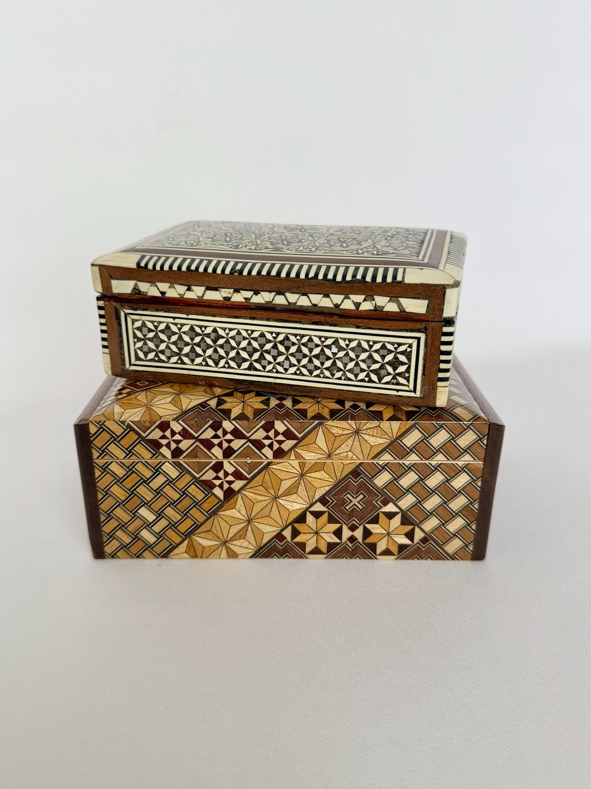 Vintage wood inlay rectangular keepsake boxes with hinged lids and in two different sizes.