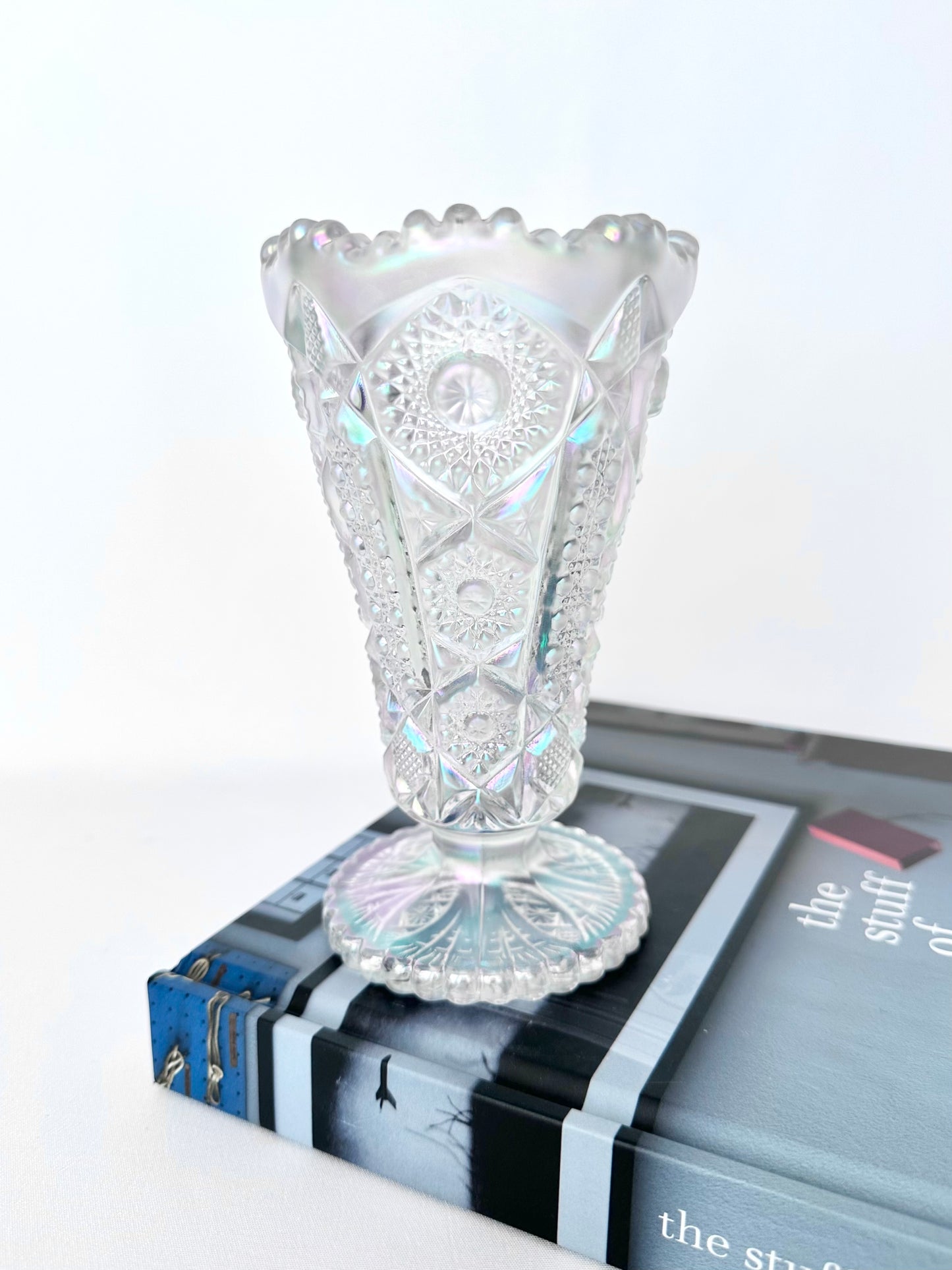 Vintage cut glass iridescent small footed vase.