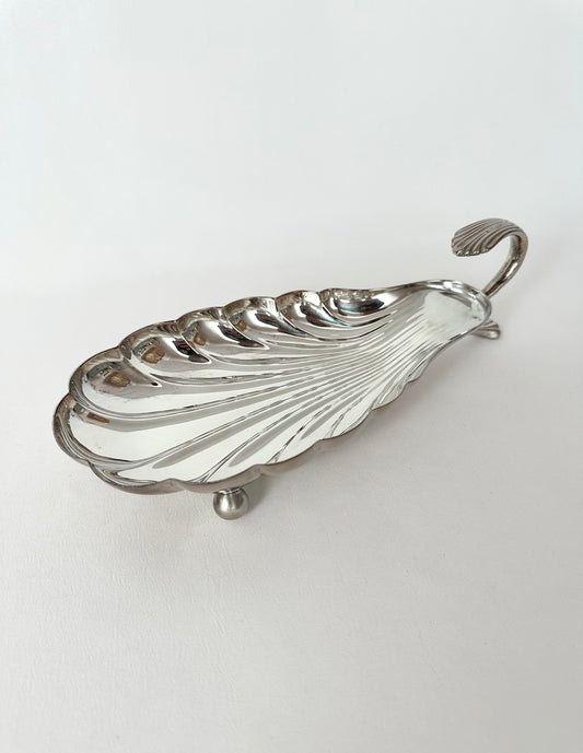 Vintage elongated seashell shaped footed serving dish with handle.