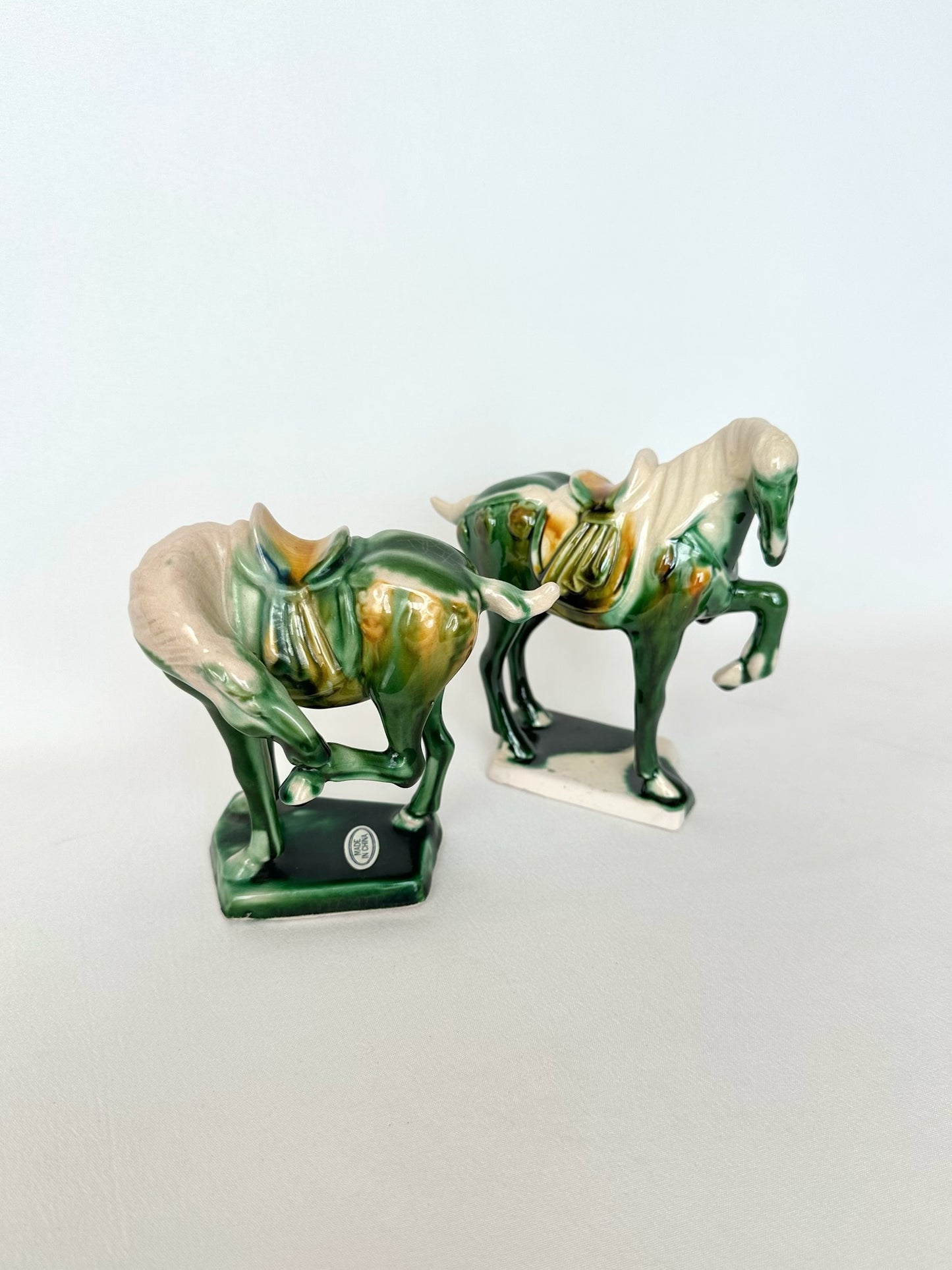 vintage Tang Dynasty style pottery war horse figurines with drip glaze and in two different poses