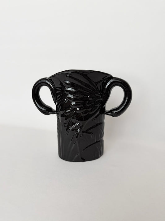 Vintage black glazed art deco style ceramic vase with a pair of flamingoes that form the handles.