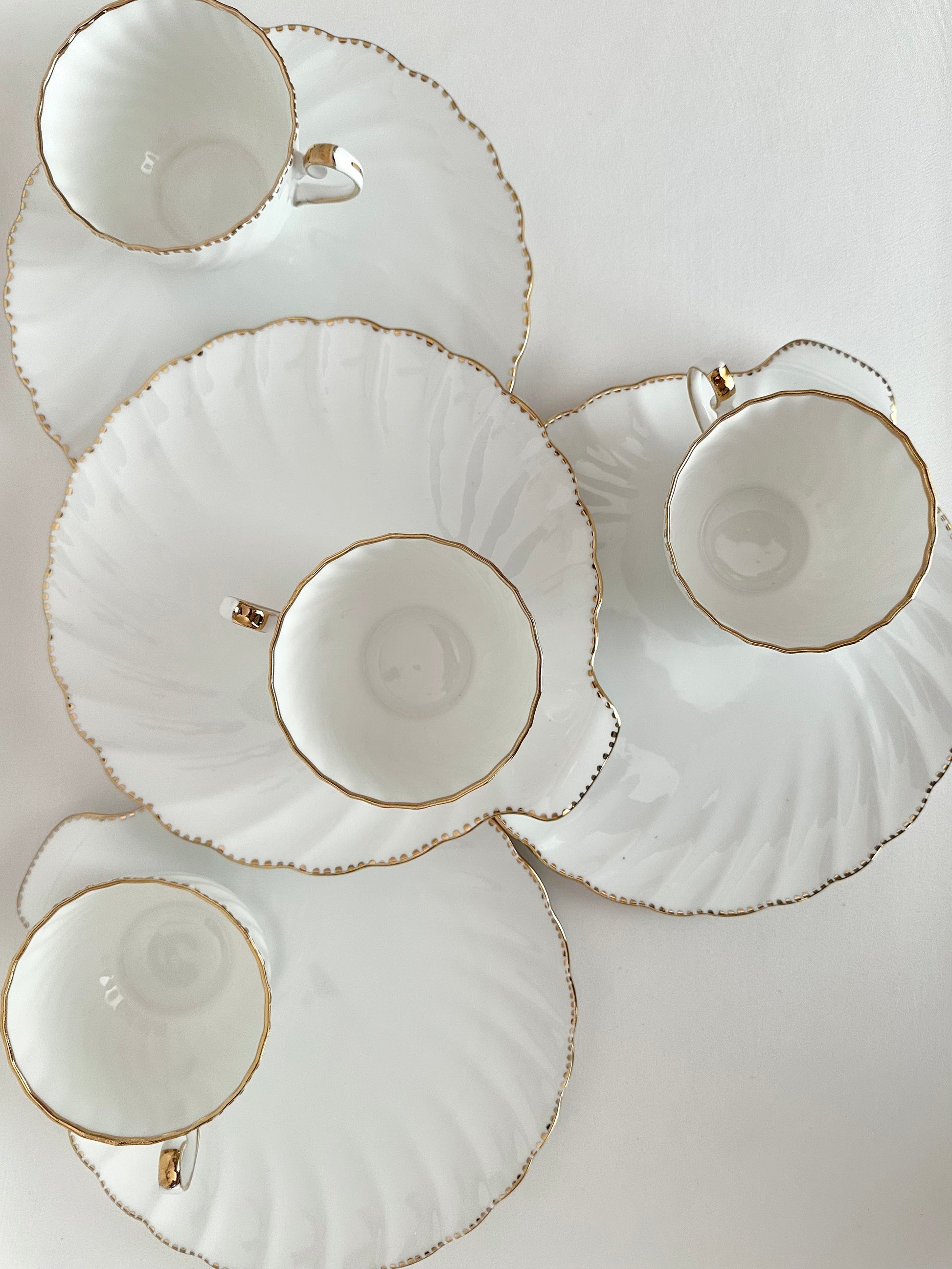 Vintage porcelain clamshell snack sets with plates and cups Set of four