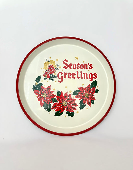 Vintage round serving tray with painted poinsettias and Seasons Greetings graphic.