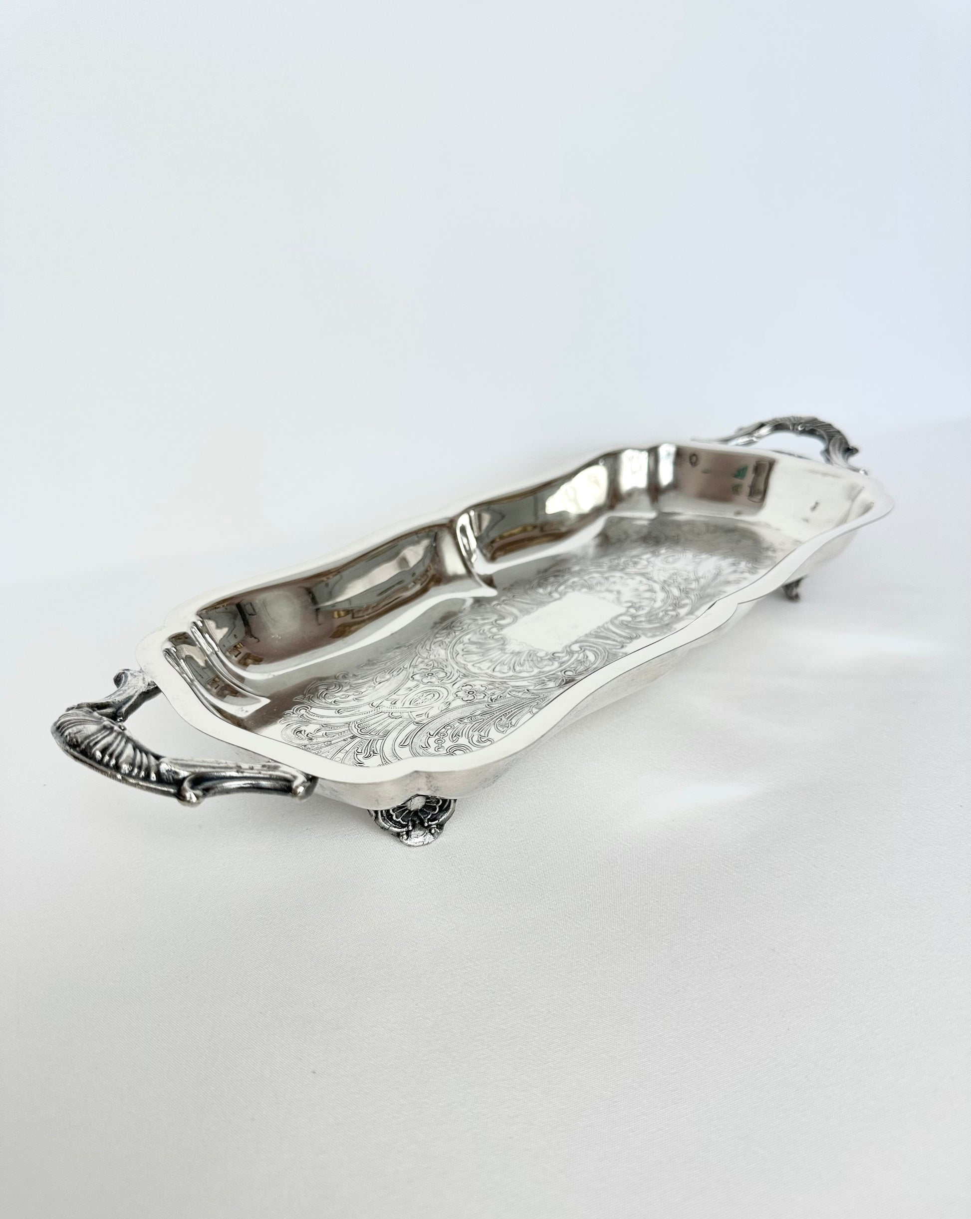 Vintage narrow silverplate footed and handles serving tray.