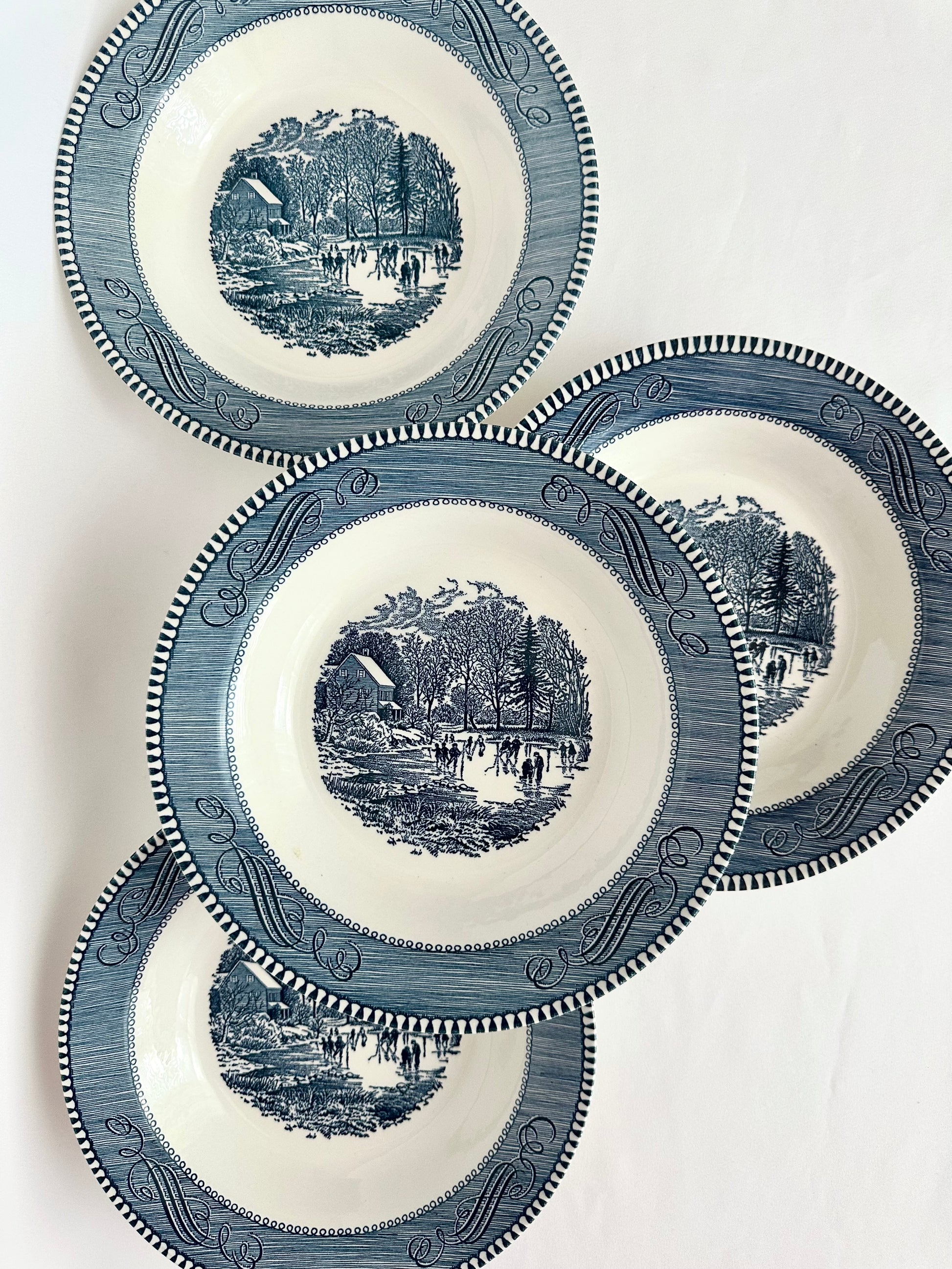 Set of four blue and white transferware soup bowls by Currier & Ives.