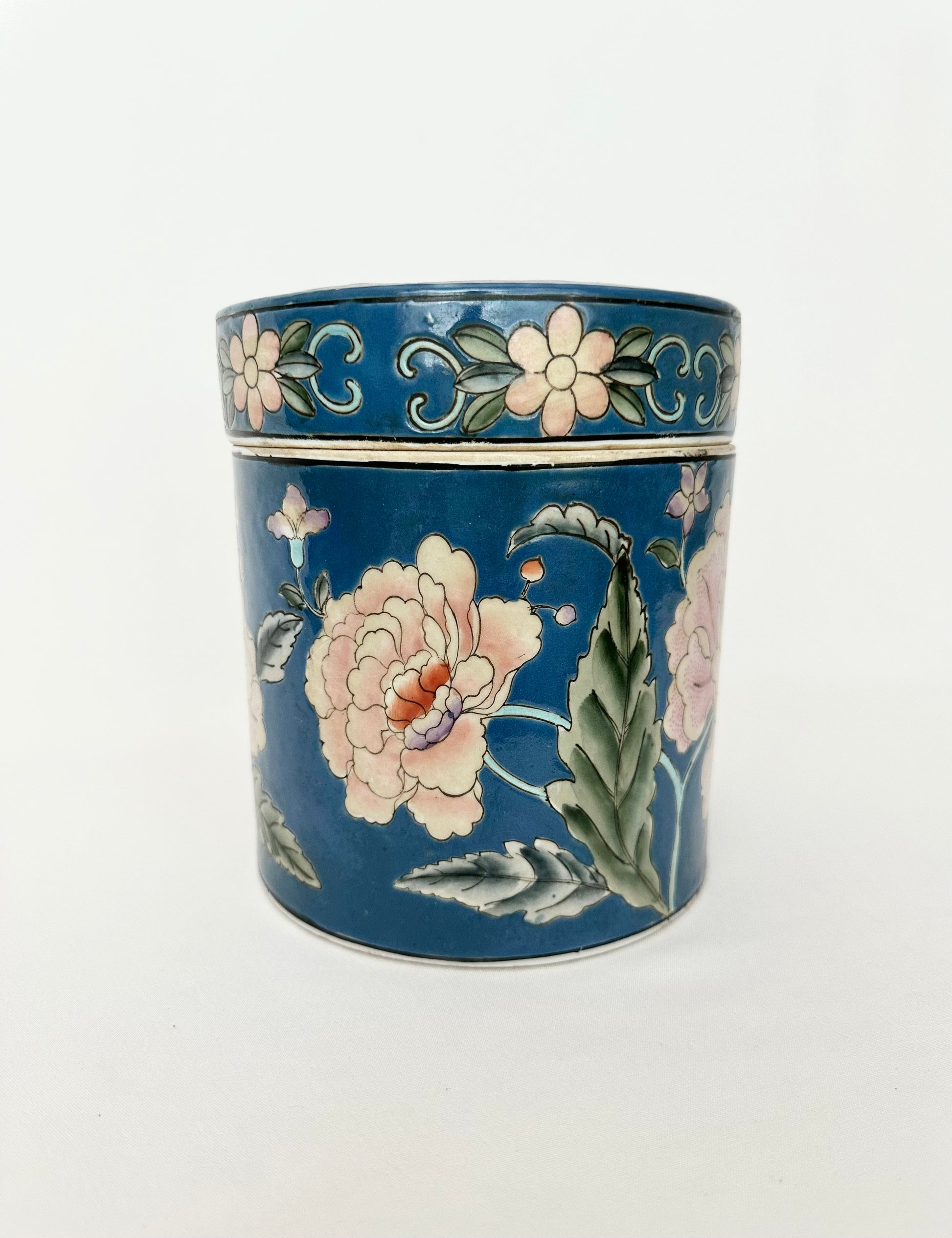 Blue chinoiserie porcelain canister with pink flowers.