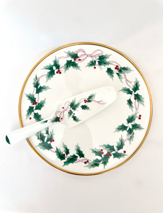 Vintage holiday themed bone china cake plate and server decorated with holly leaves and pink ribbon by Mikasa.