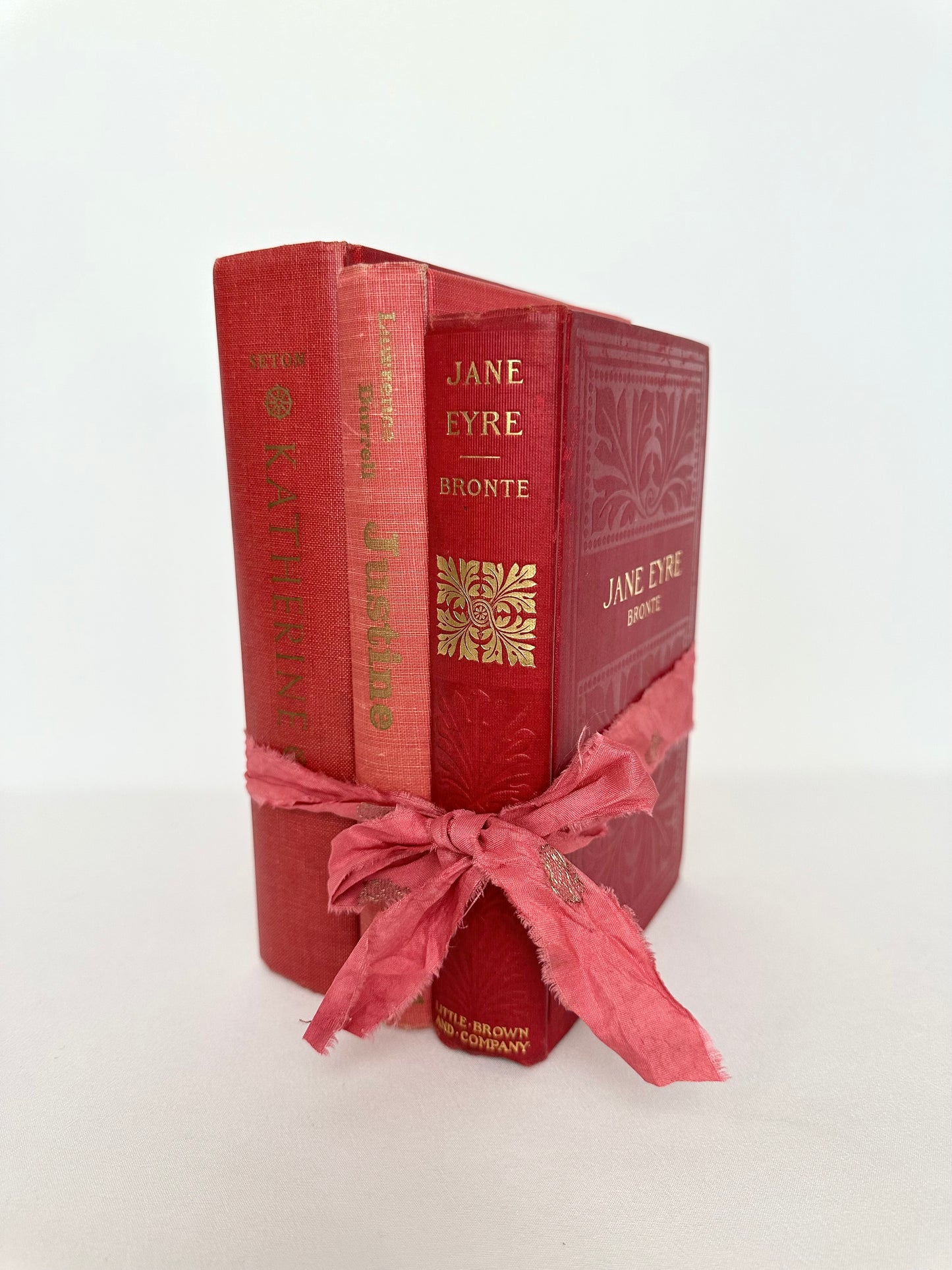 Vintage and antique red hardcover book stack set of three- women's name theme.