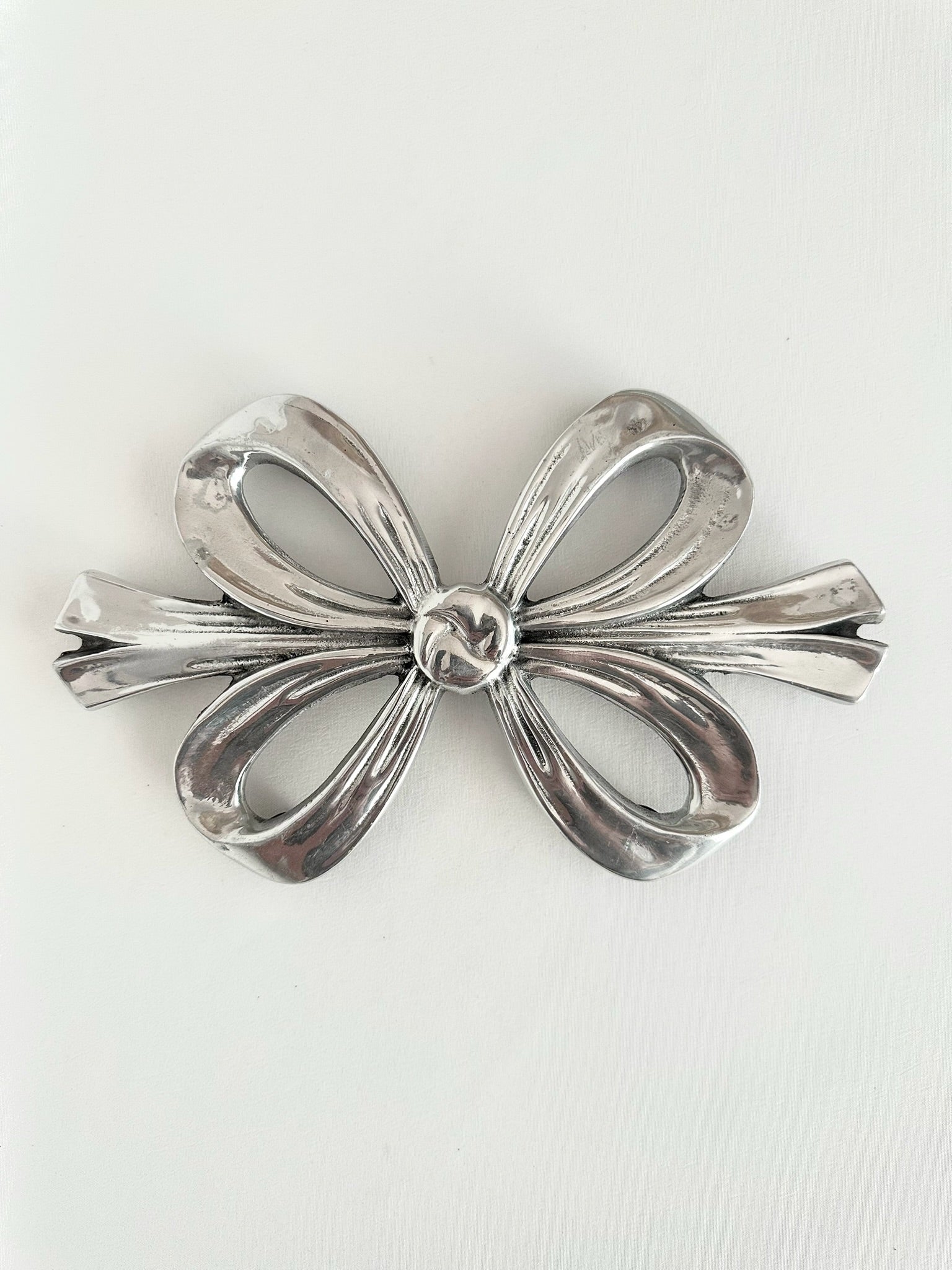 vintage silver pewter bow shaped trivet with rubber feet