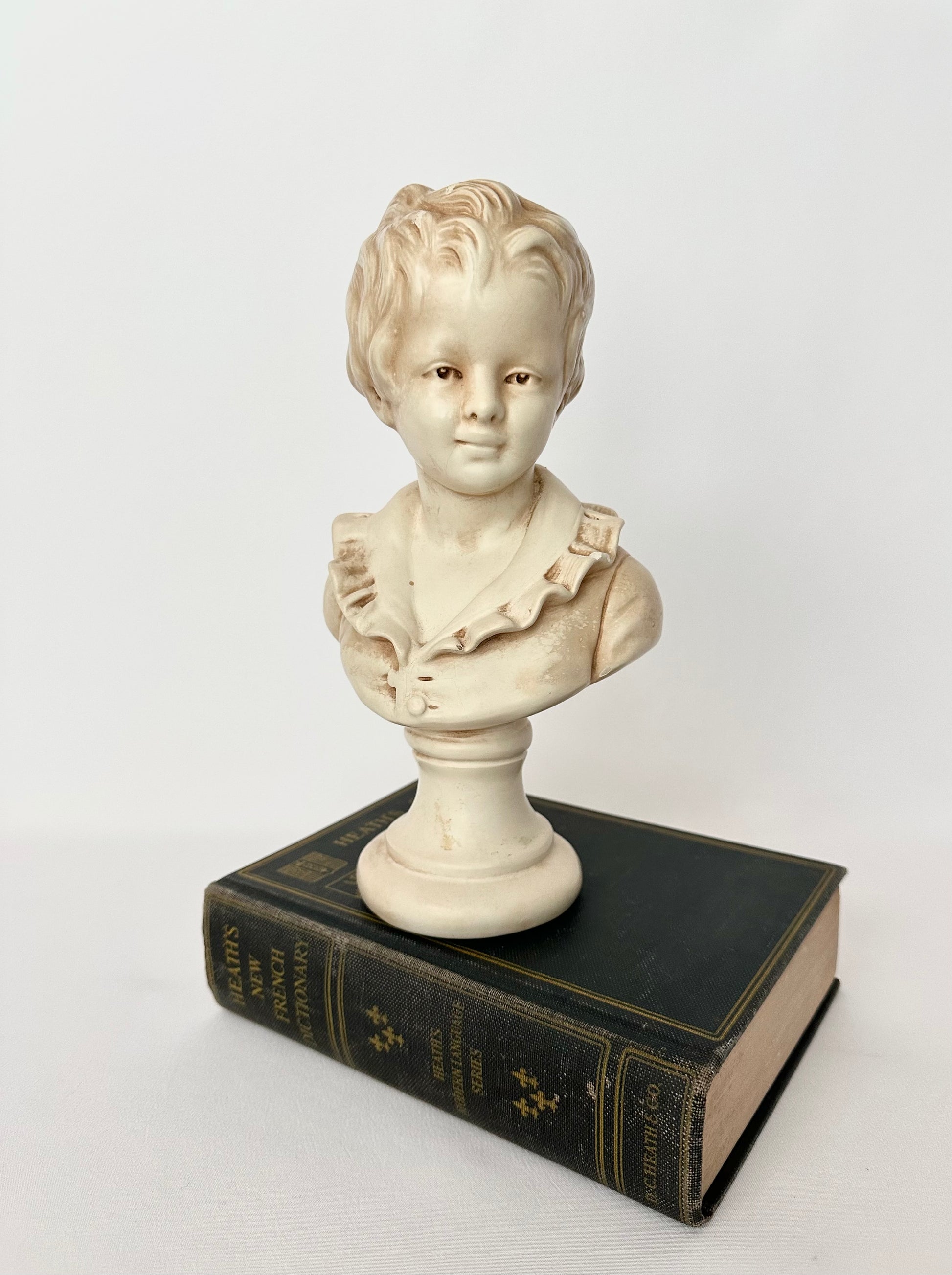 vintage classical bust of a young boy on a pedestal