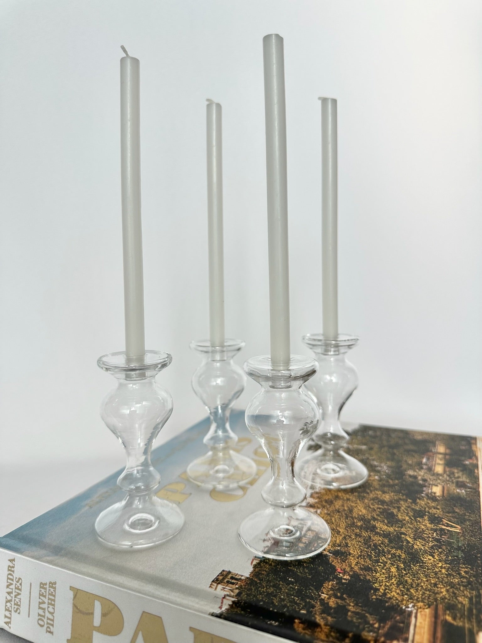 mini handblown clear glass candlestick holders with mini white tapers set of four