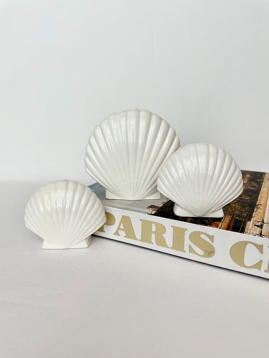 Off white ceramic clamshell napkin holder and salt & pepper shaker set.