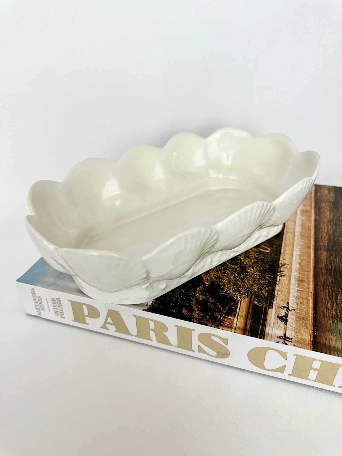 Vintage cream ceramic oblong serving bowl with seashell pattern. 