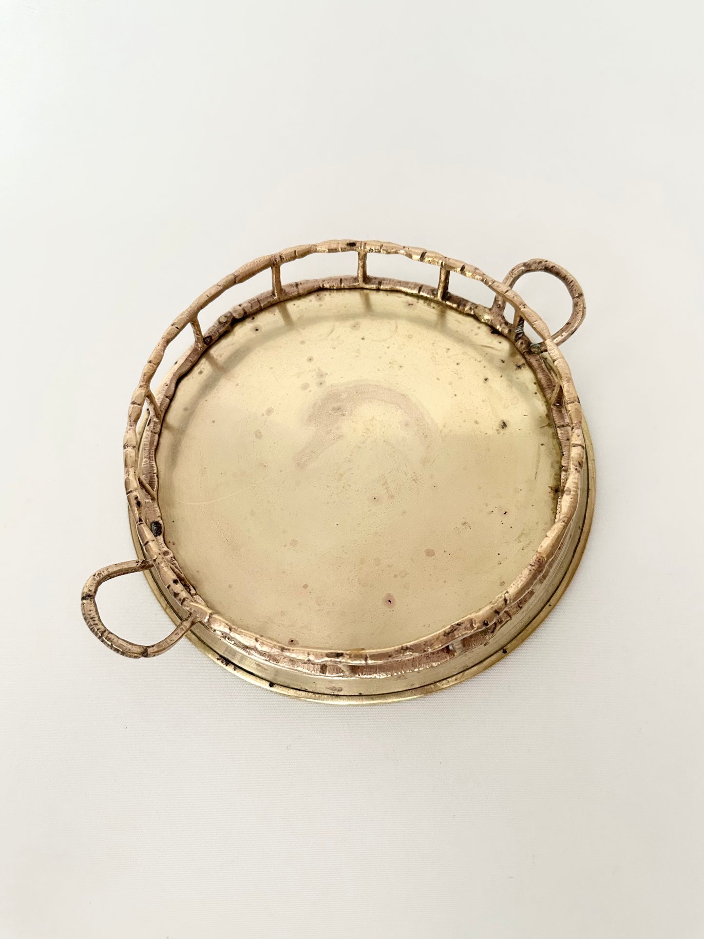 Vintage small round brass tray with bamboo shaped rim and handles.