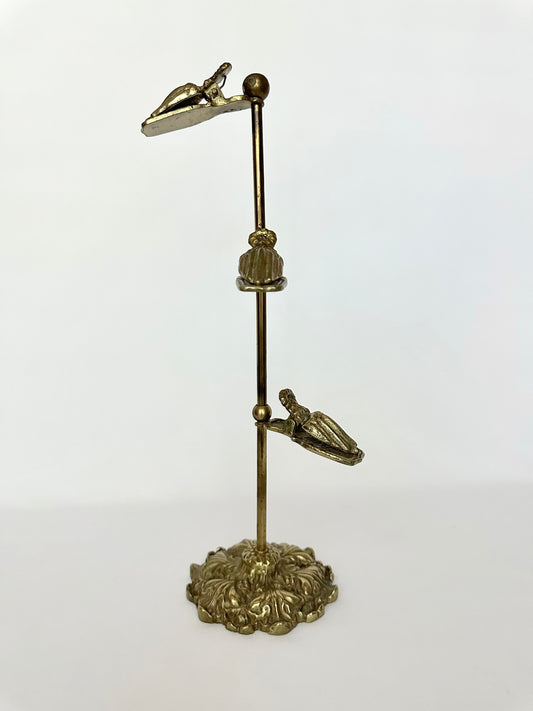 Vintage brass hand clip glove stand.