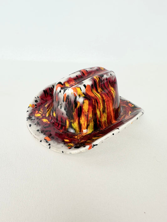 Vintage drip glazed ceramic cowboy hat figurine in oranges, reds, yellows, black and white