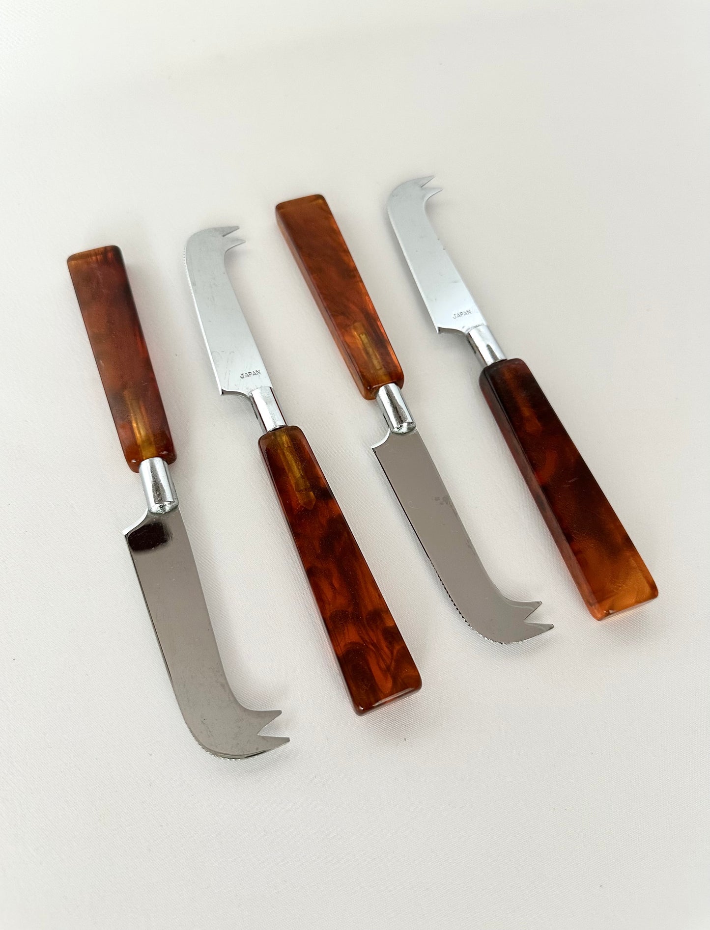 Vintage tortoise shell Bakelite handled cheese knives set of four.