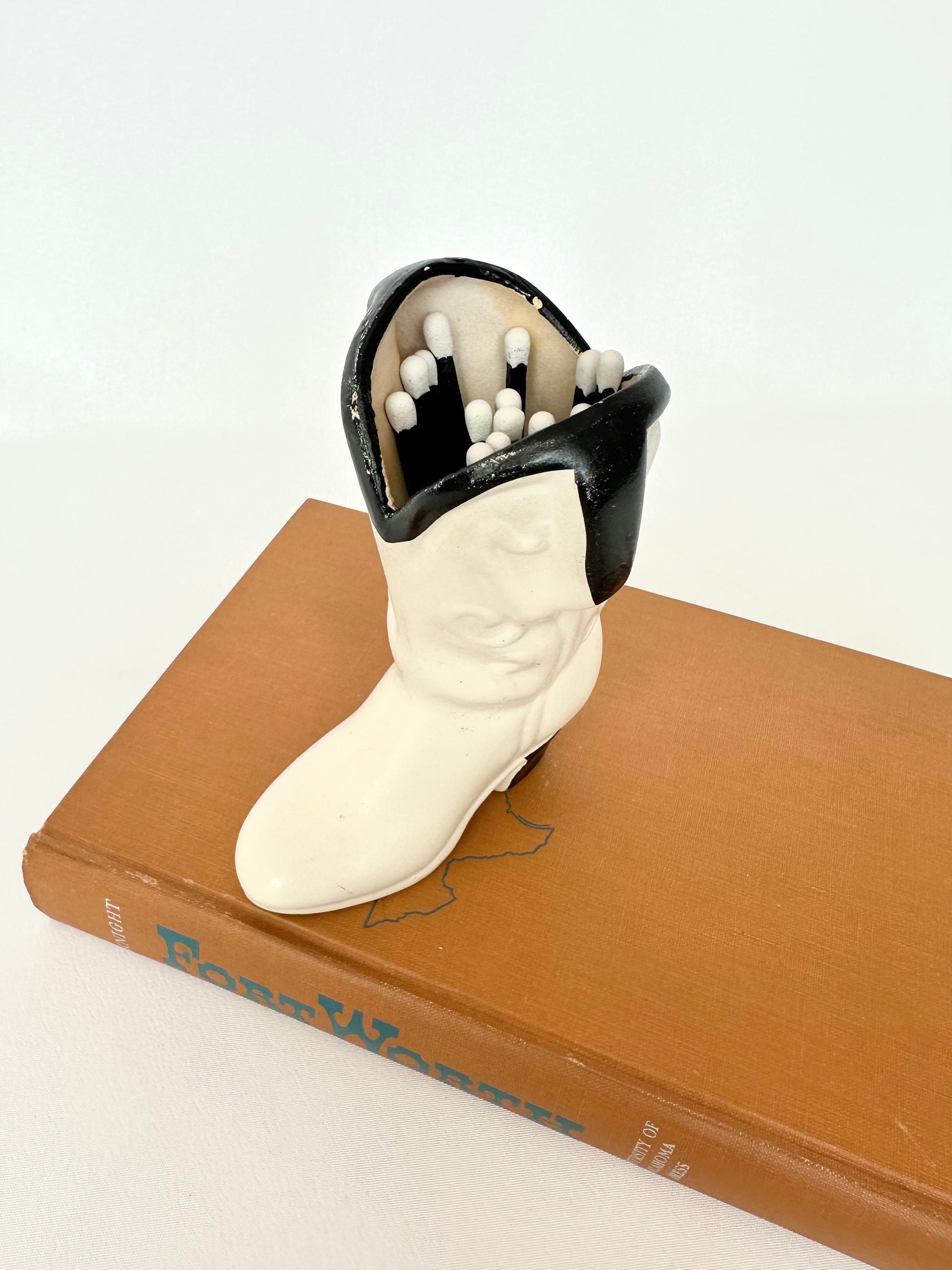 Vintage off white and black cowboy boot matchstick vessel paired with 20 black and white matchsticks