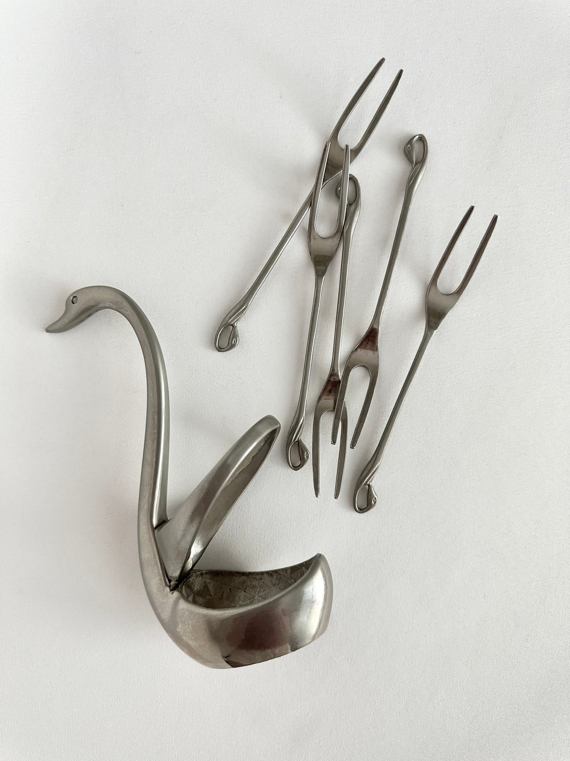 Vintage silver metal swan shaped appetizer fork holder with five appetizer forks.