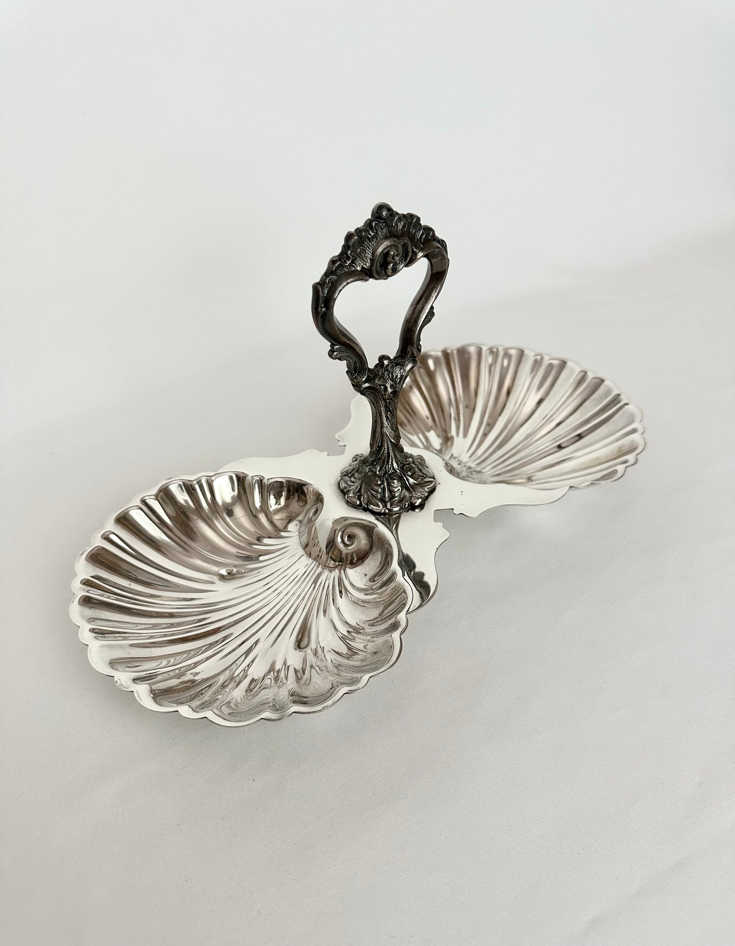 Vintage silverplate handled double seashell serving piece.