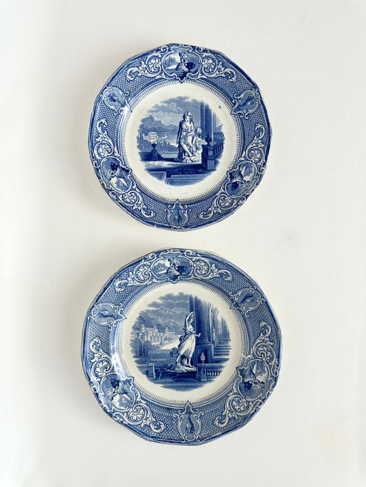 antique blue and white transferware decorative plates with scenery including buildings and people