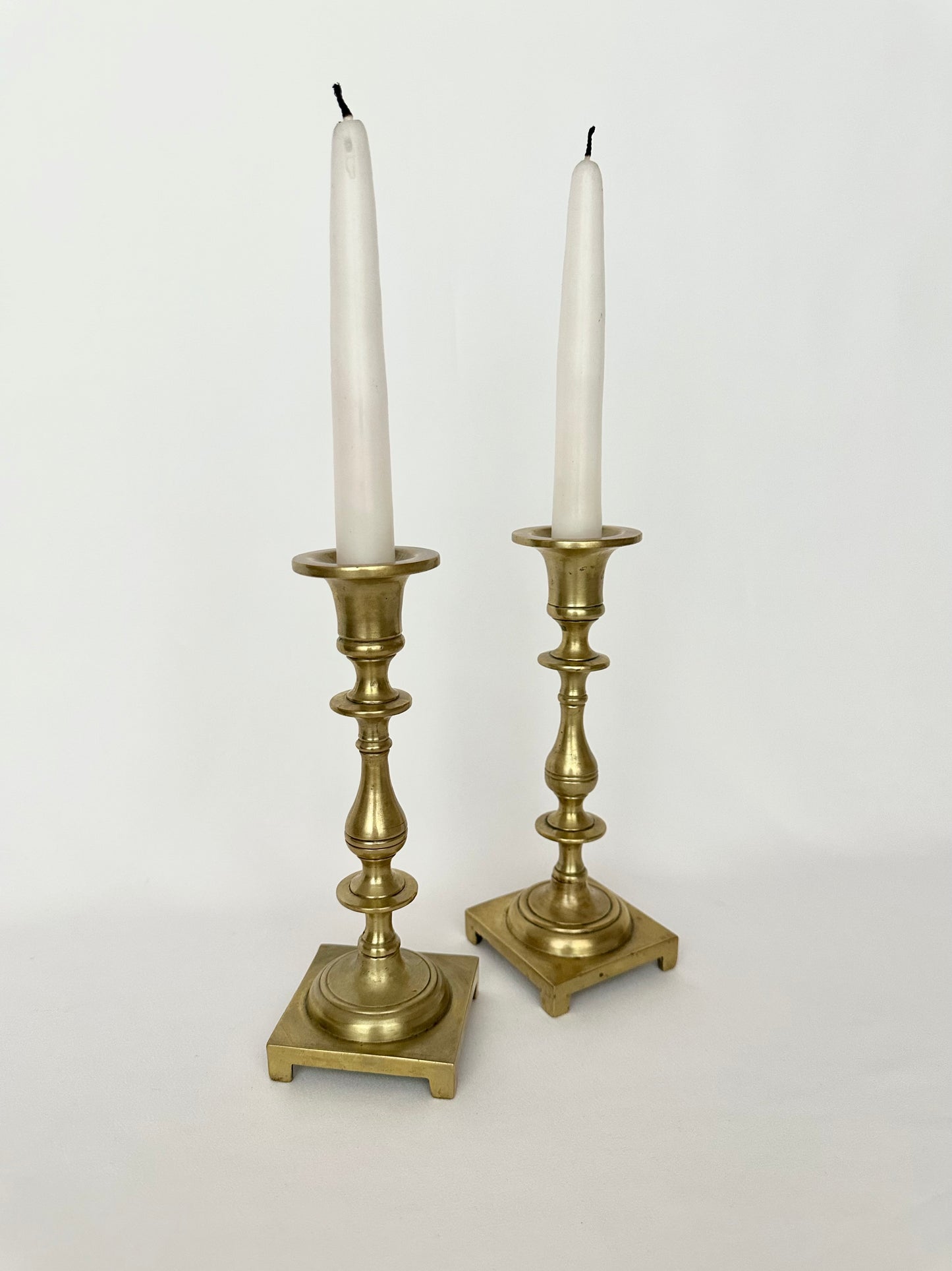 Vintage footed brass candlestick holders set of two.