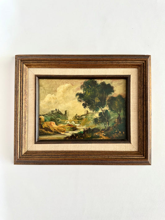 vintage framed original oil painting of a landscape with hills, woods and a castle type building
