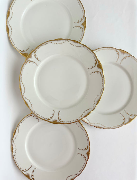 Vintage cream colored dinner plates set of four with gold gilt trim by Limoges.