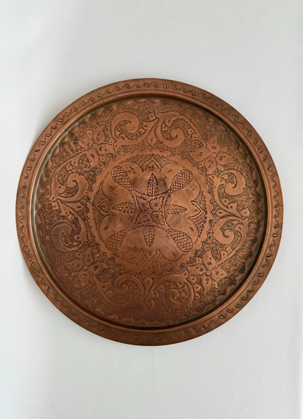 Vintage large round engraved copper serving tray.