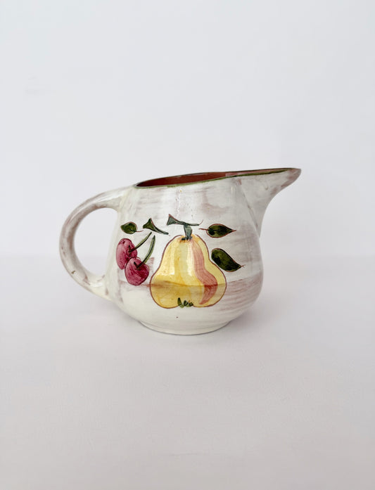 small vintage glazed ceramic pitcher with fruit detail in off white and brown interior