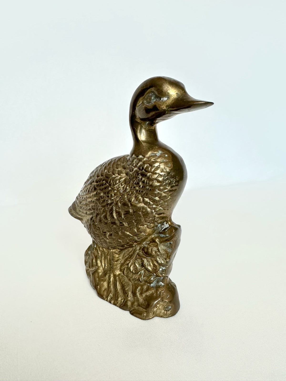 Vintage solid brass duck figurine with patina.