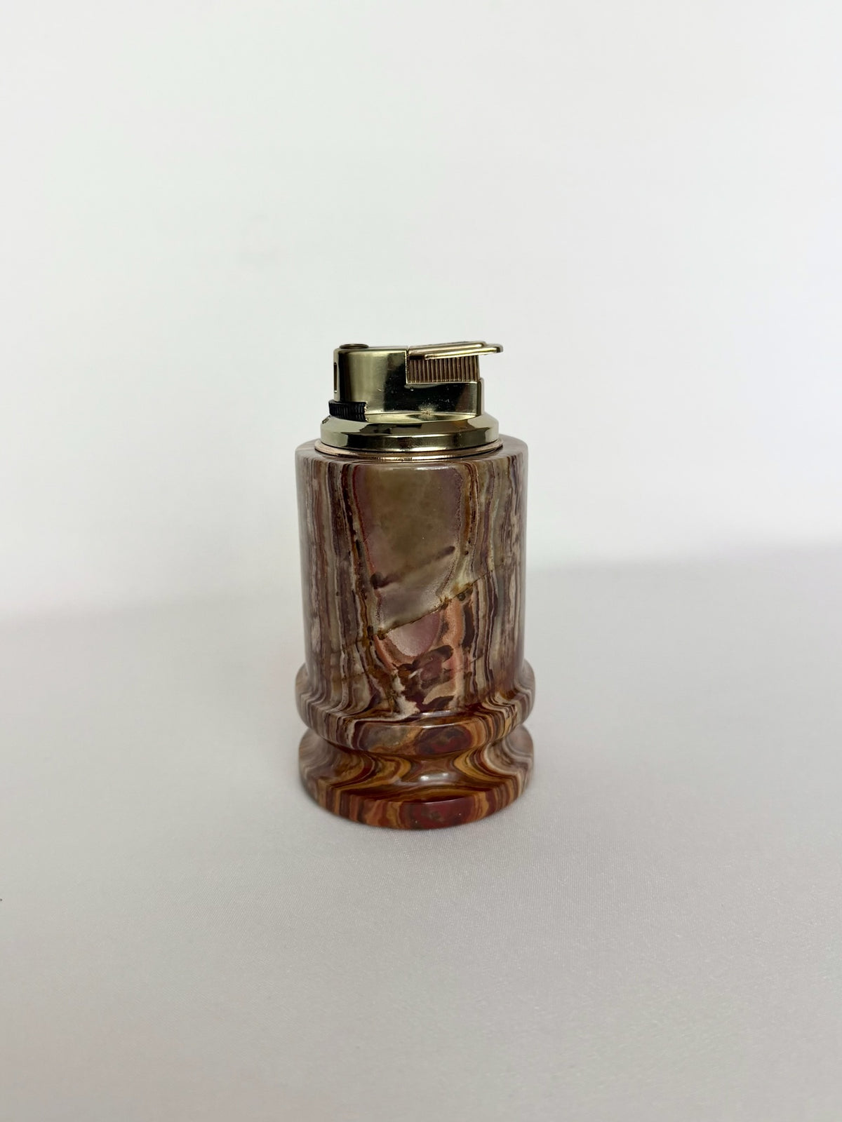 Vintage onyx cylinder shaped table lighter with removable metal fuel chamber, untested.