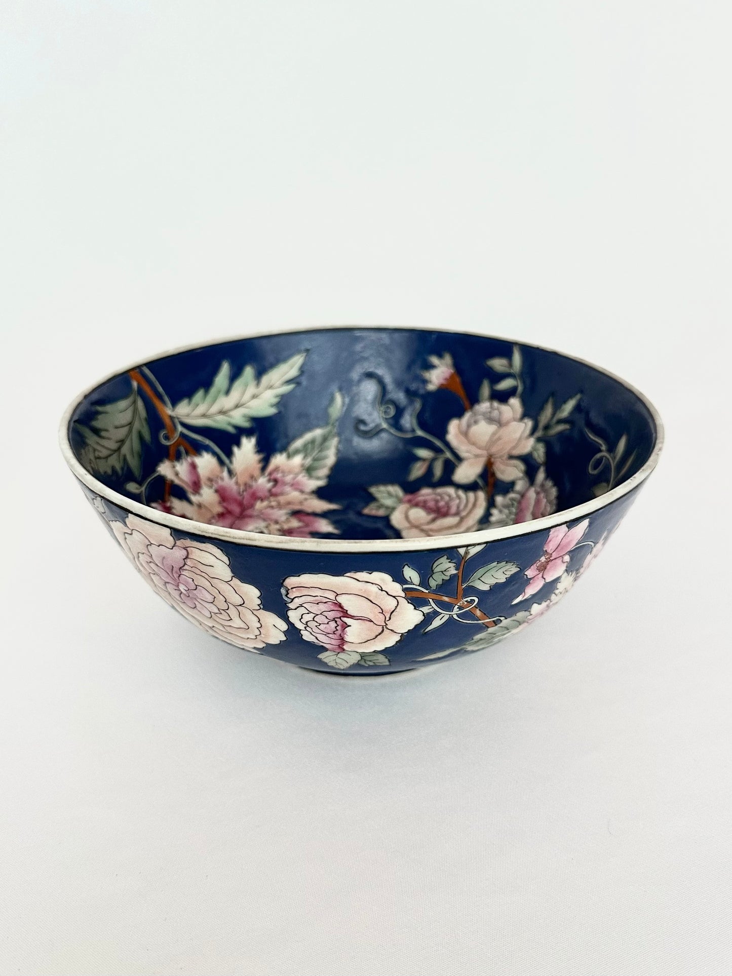 Vintage dark blue chinoiserie decorative bowl with pink flowers.