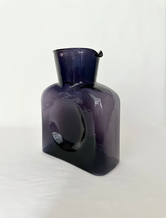 Amethyst purple glass double spouted glass pitcher.